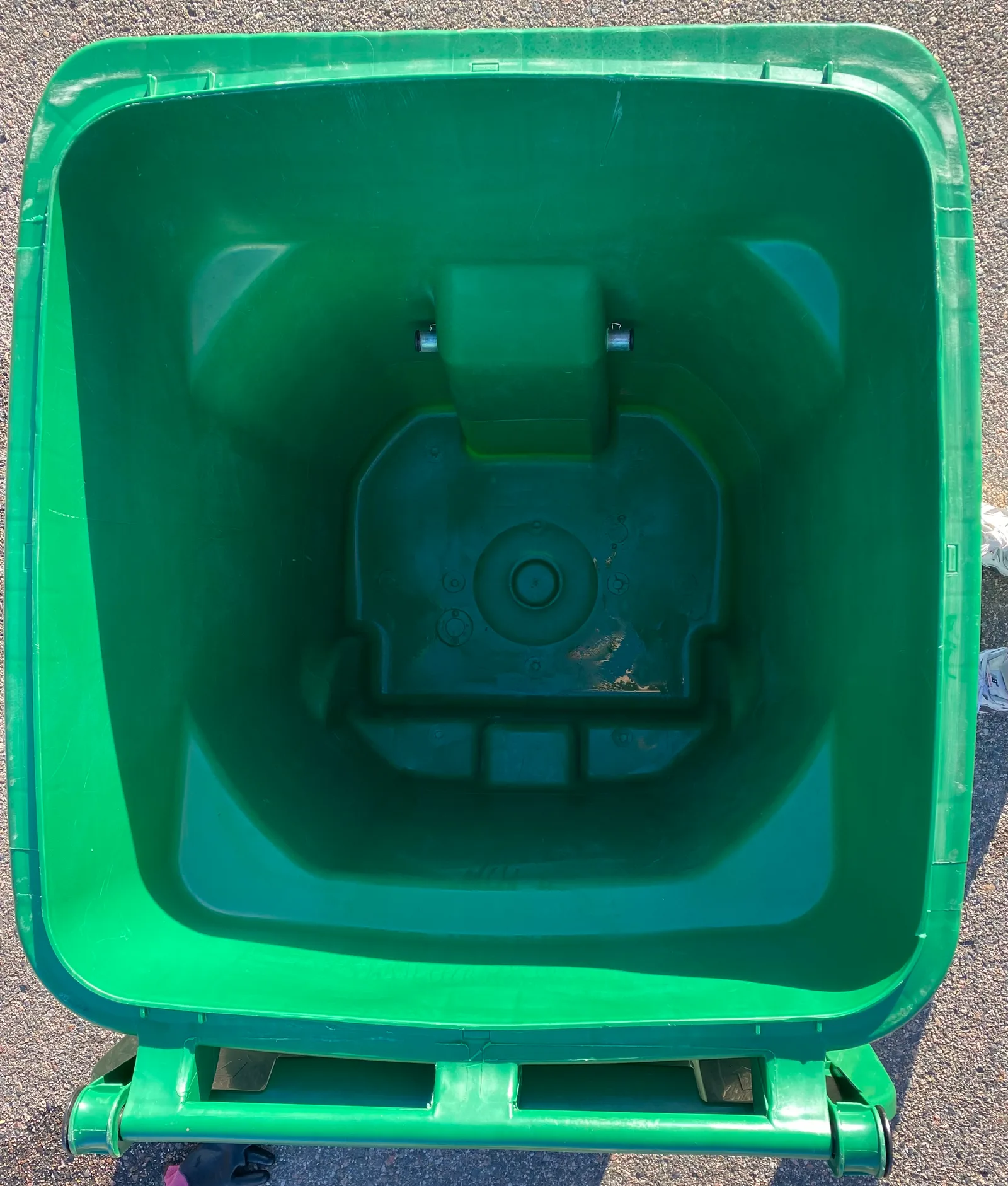 Same green curbside trash bin after Britebin cleaning, with a cleaner interior and fresher presentation